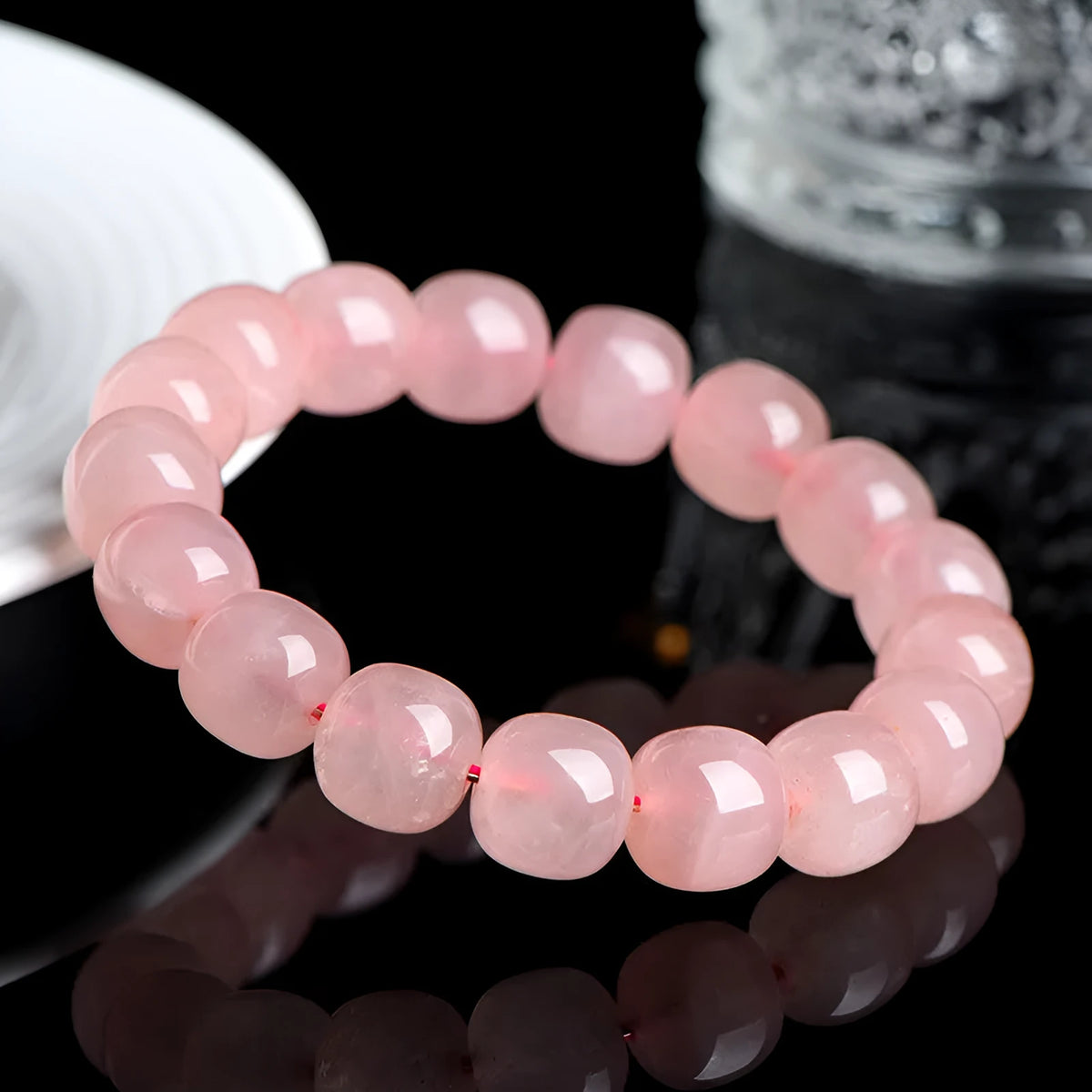 Pink crystal barrel bead bracelet with geometric 8x10mm beads on wrist