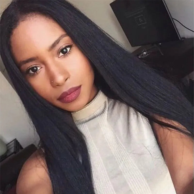 Long straight black synthetic wig on a mannequin head, featuring a centre parting and straight-cut bangs.