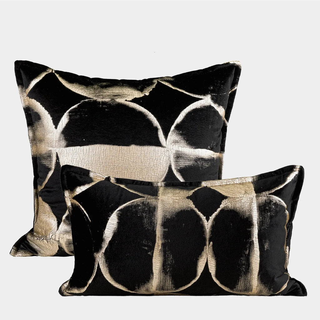 Black gold abstract pattern decorative cushion with removable cover in three size options on a sofa.