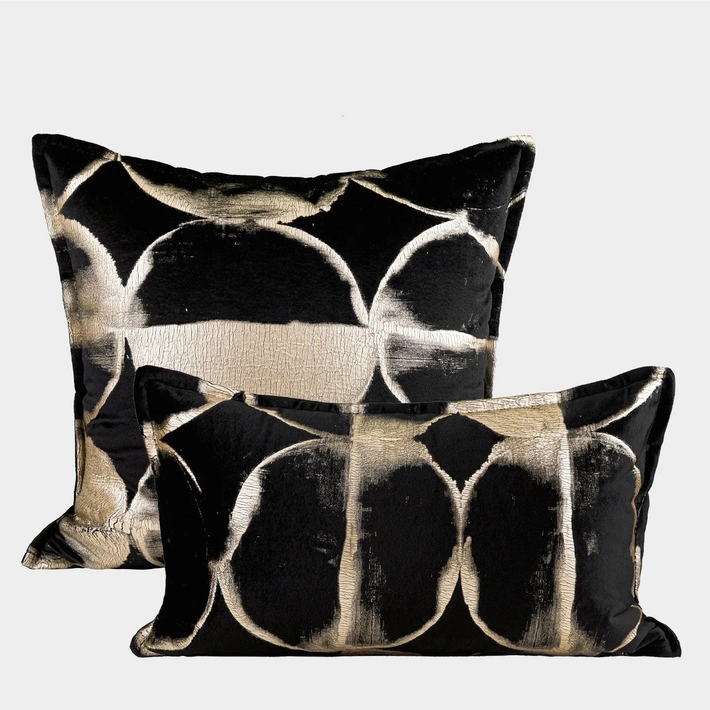 Black gold abstract pattern decorative cushion with removable cover in three size options on a sofa.