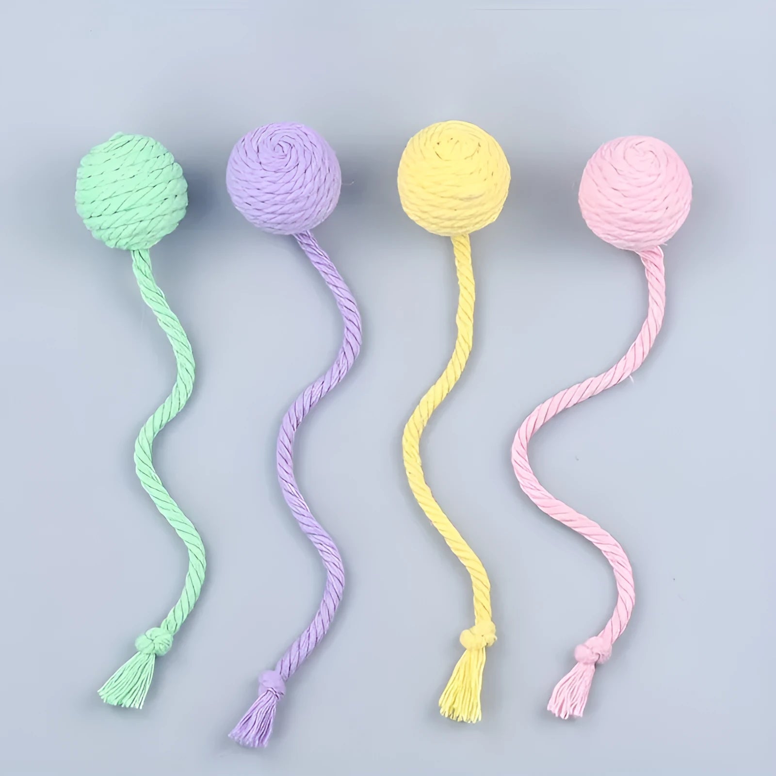 Colourful cat toy ball with a rope and built-in bell for interactive kitten play.
