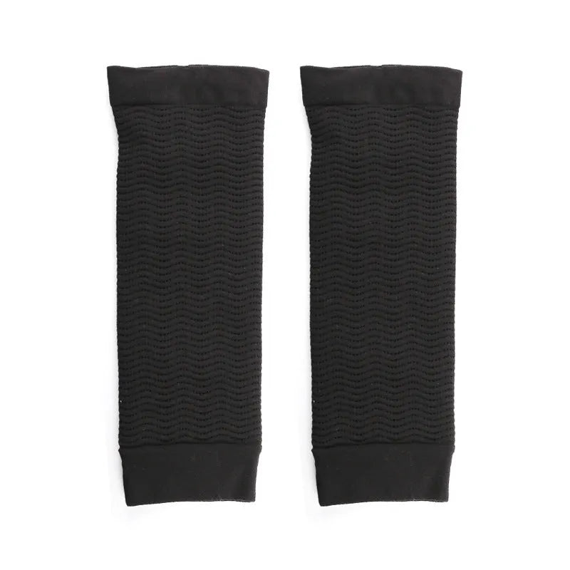 Women's black and skin tone nylon shaping arm sleeves laid flat, free size.
