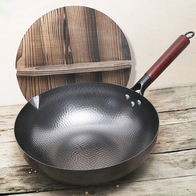 Traditional black iron wok with wooden handle, 40cm diameter.