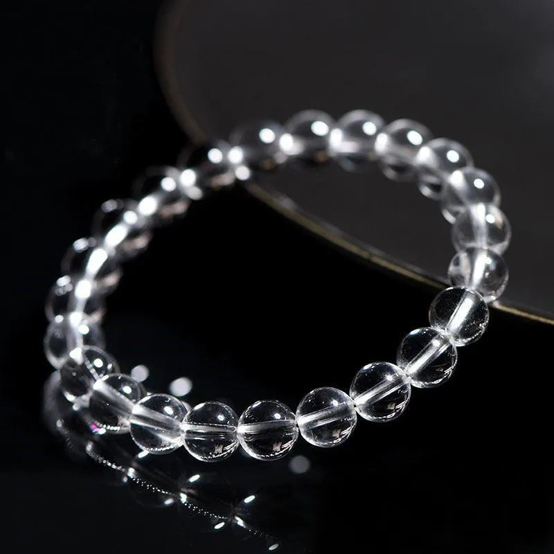 Natural white crystal bead bracelet with round beads on a single strand, geometric unisex design.