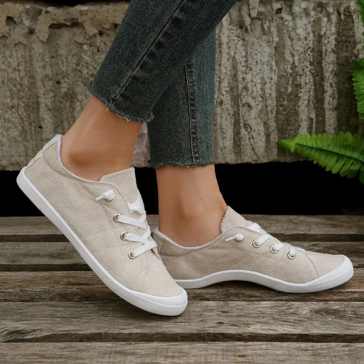 Women's creamy-white casual sneakers with low top fabric upper and rubber sole