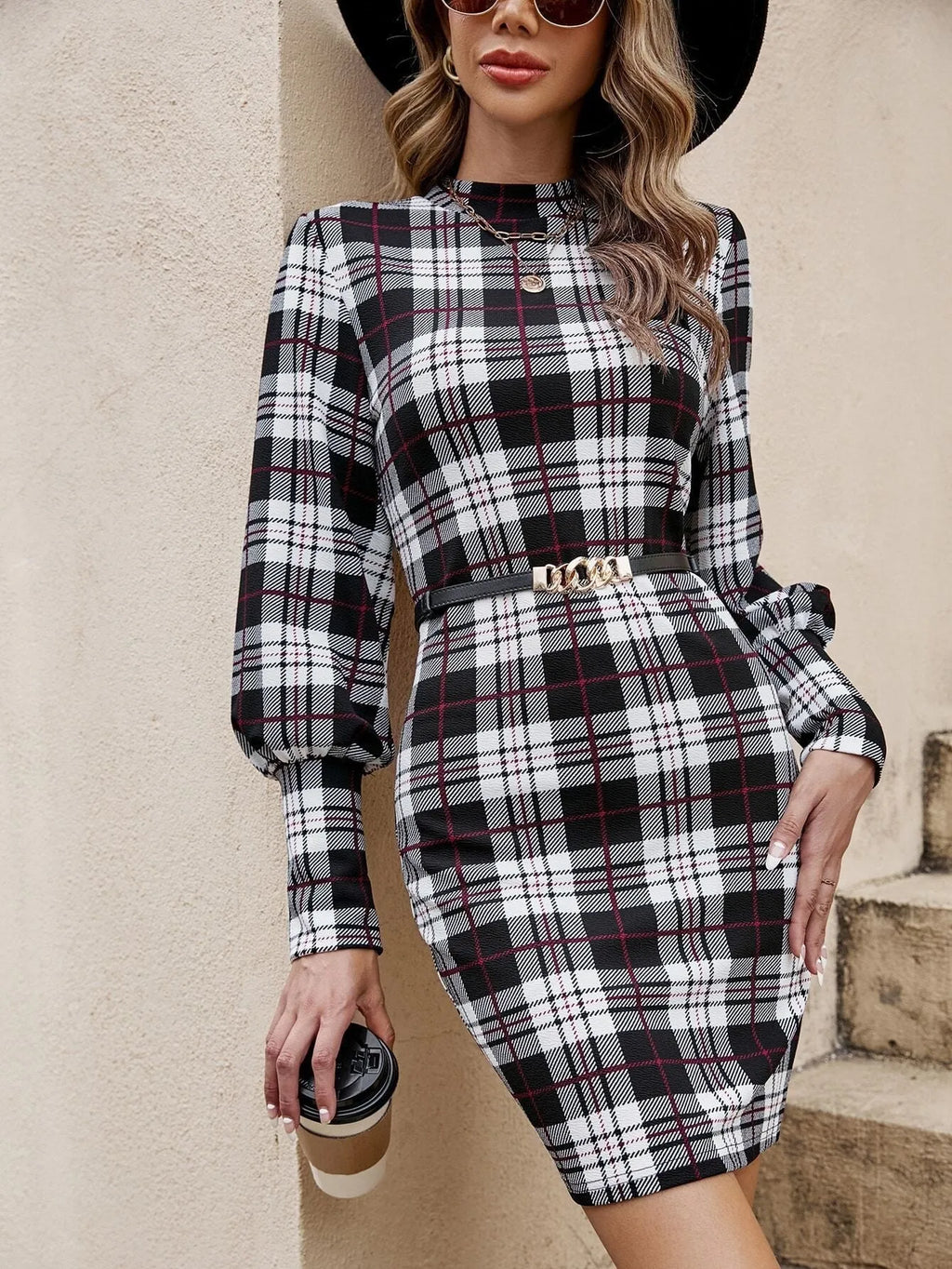 Black fitted midi dress with full lantern sleeves and decorative leather stitching detail.