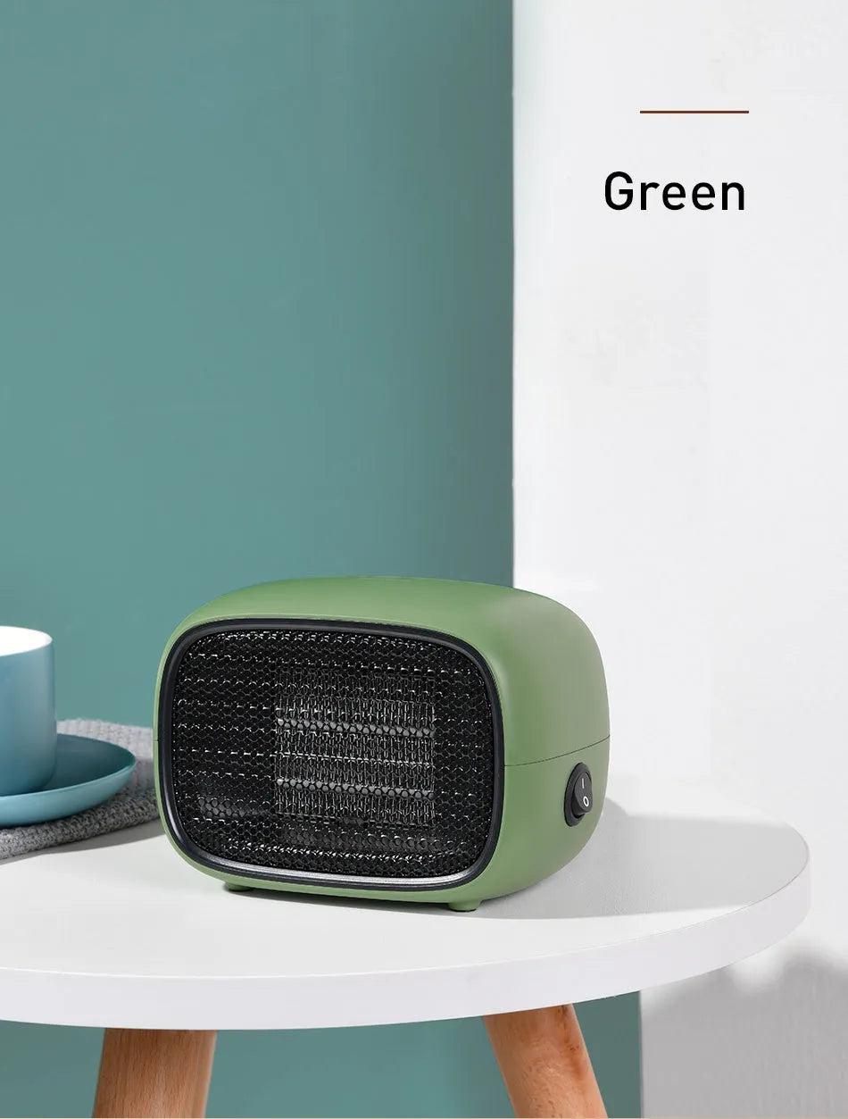 Compact green portable heater with metal grille showing dimensions 158mm x 90mm x 114mm.