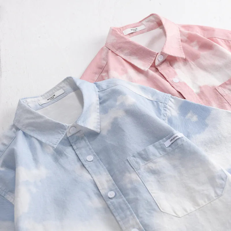 Man wearing a light pink loose-fit short-sleeved cotton cardigan style shirt.