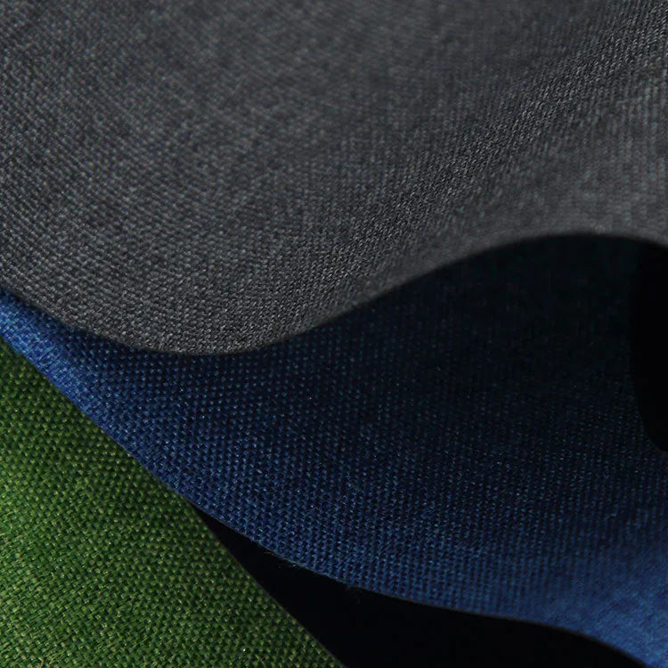 Black, blue, and green swatches of polyester Ant Cloth fabric on a roll.