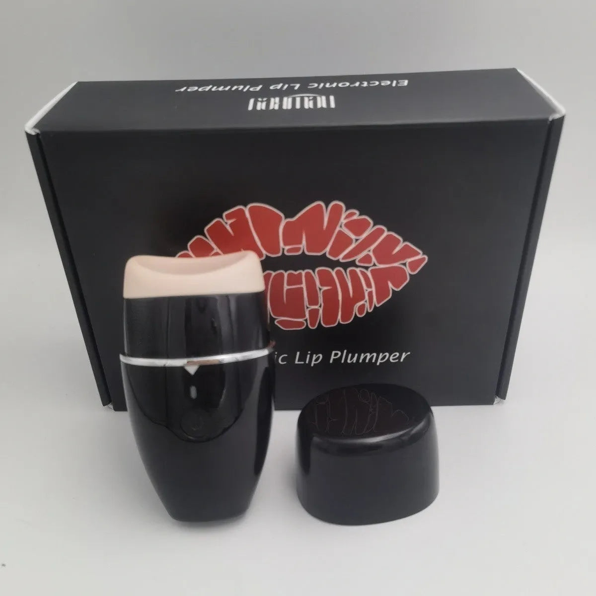 Black and white electric silicone lip plumper device with USB charging cable
