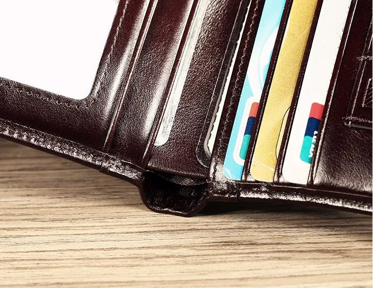 Men's leather organiser wallet open to show internal compartments including card slots and a zipped coin pocket.