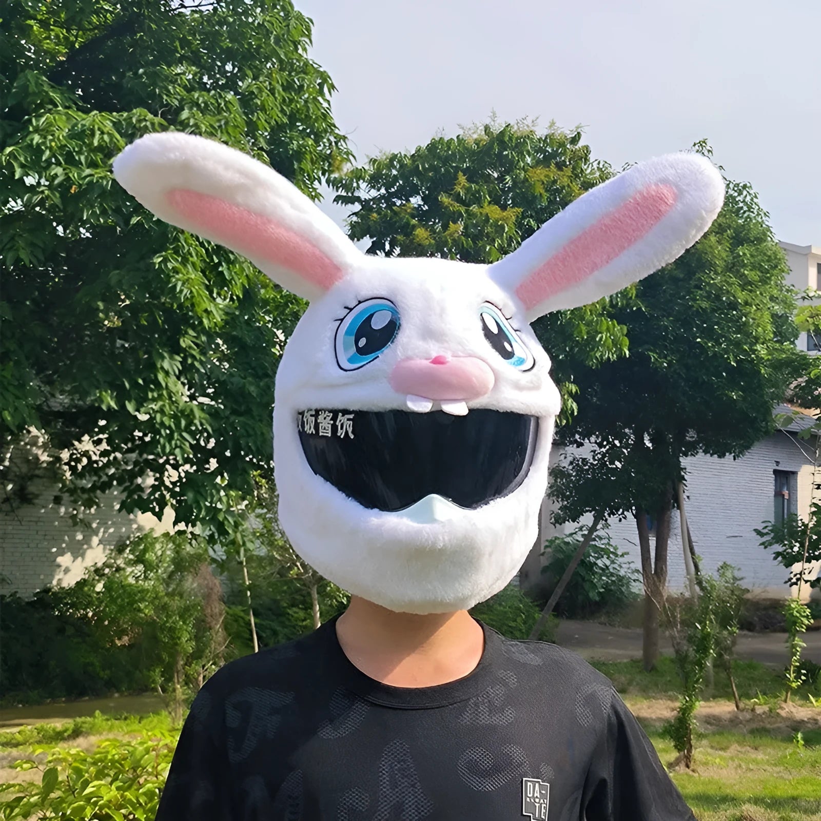White long-eared rabbit head plush cover on an electric motorcycle helmet.