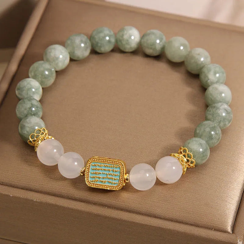 Oil green emerald crystal bracelet for women with five engraved beads.