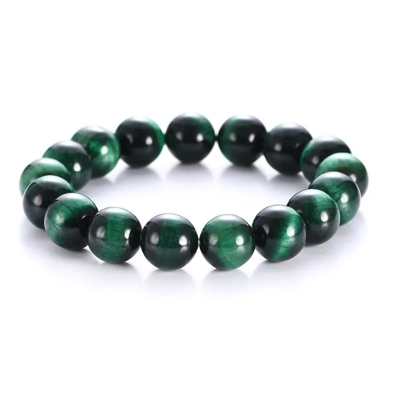 Natural green tiger eye stone bracelet with geometric polished beads on a wrist.