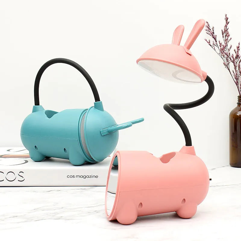 Simple cartoon-style USB desk lamp with pen holder base in green, dark blue, or pink