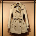 Khaki women's double breasted trench coat with flight sleeves showing button detailing