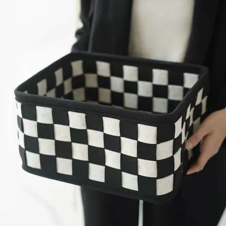 Checkerboard patterned grey felt folding storage basket shown upright and collapsed flat.