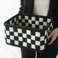 Checkerboard patterned grey felt folding storage basket shown upright and collapsed flat.