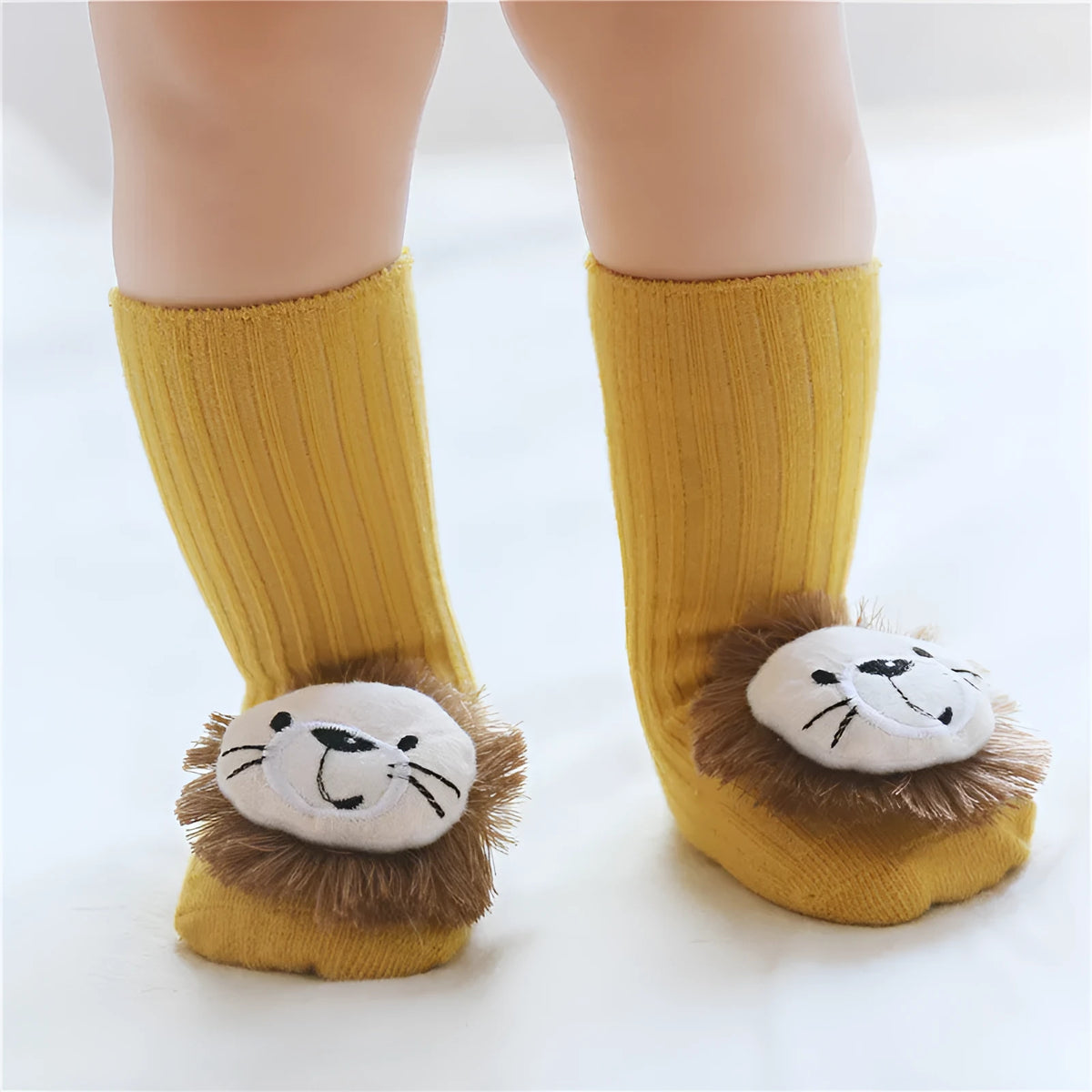Cotton baby floor socks in a selection of colours and patterns like panda, lion, and bows, shown in sizes for infants.