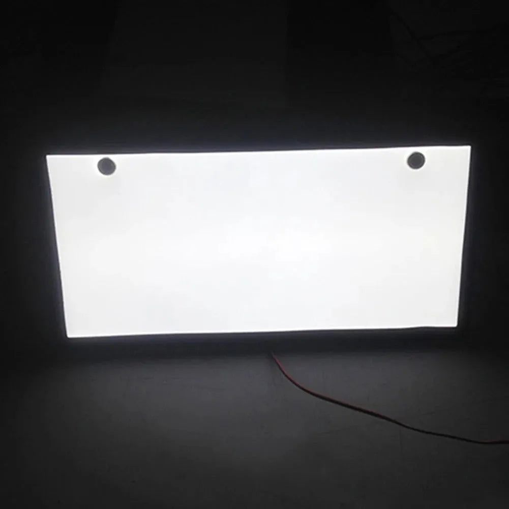 Two white plastic LED license plate lights for truck rear installation.
