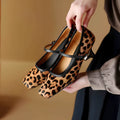 Women's black square toe stiletto ankle-strap high heels with horse hair upper shown from side angle