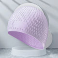 Silicone swimming cap for adults shown in one of nine solid colour options.