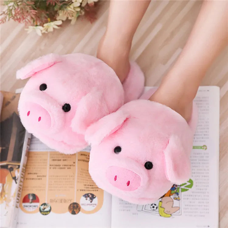 Pink pig-shaped floor slippers with short plush fabric and a soft padded interior.