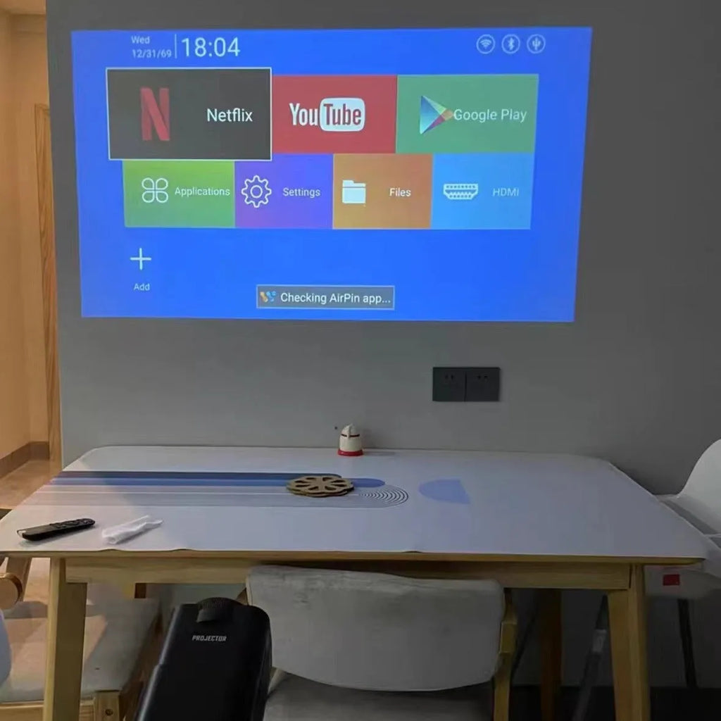 Wireless home gaming projector with HD 720p resolution displayed alongside gaming console