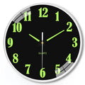 Modern 8-inch luminous wall clock with white plastic case on a wall.