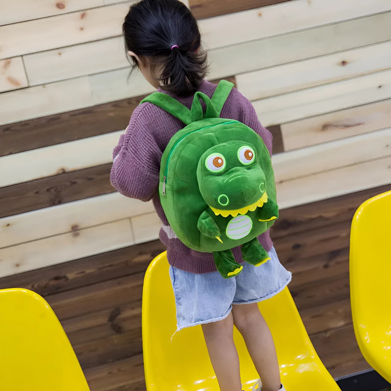 Blue dinosaur plush backpack for children with embroidered character and soft handle