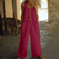 Sleeveless cotton wide leg jumpsuit in various colours on a hanger, showing loose fit and pockets.