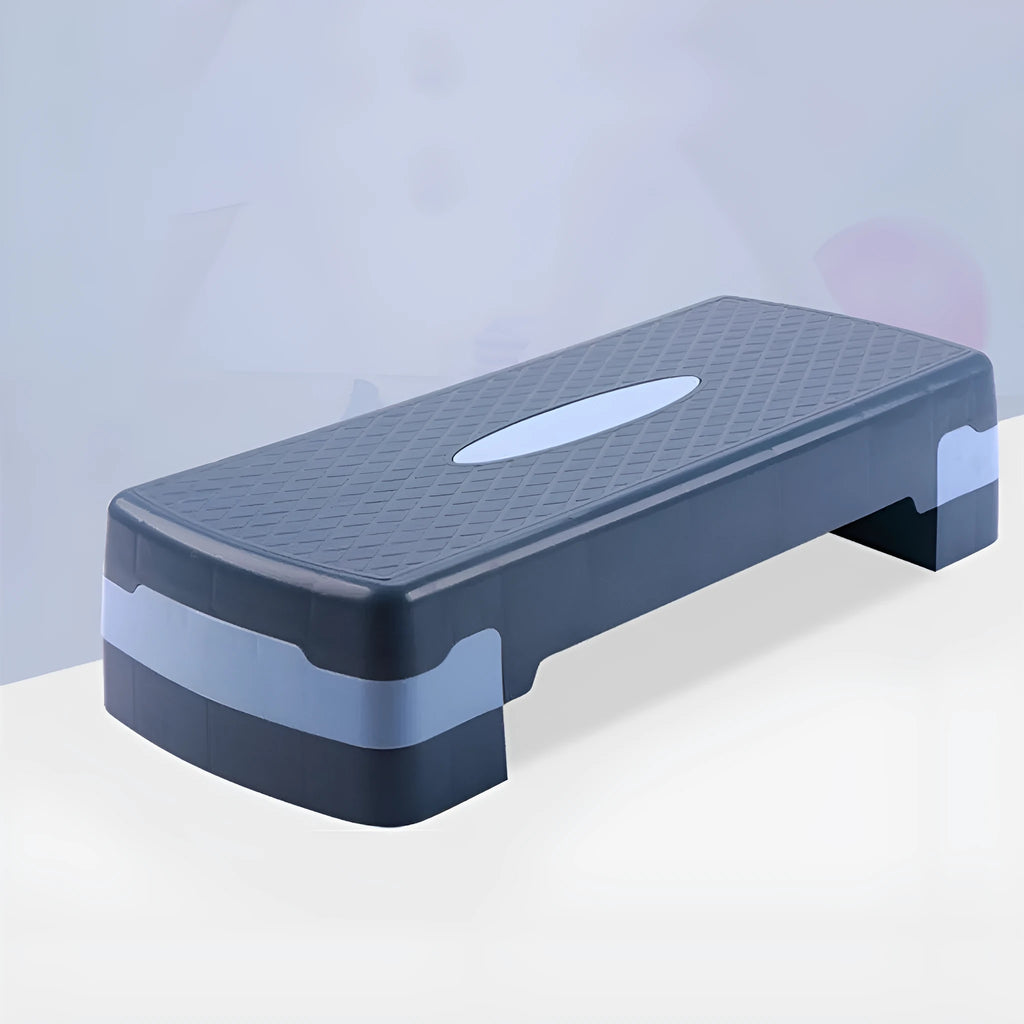 Grey fit step aerobics platform made of ABS plastic on a wooden floor.