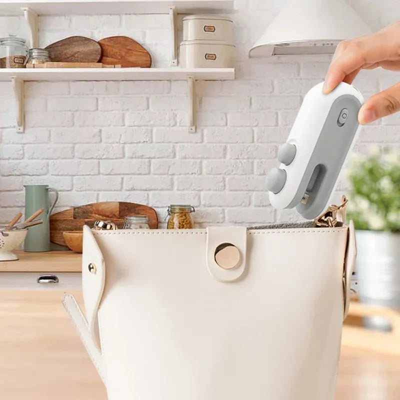 White handheld USB rechargeable heat sealing machine for chip bags with magnetic back and cutter