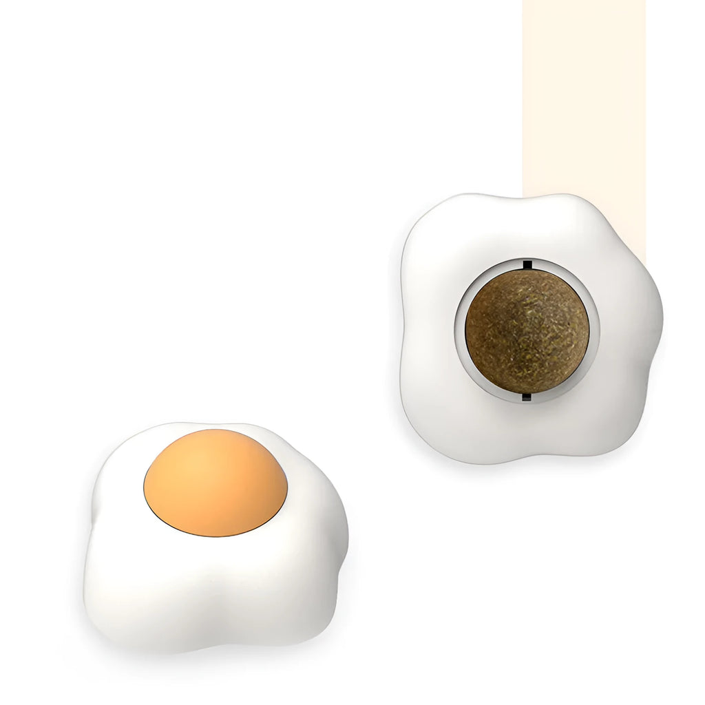 Interactive plush catnip ball toy stuck on a wall, showing Fried Egg and Poached Egg shape options.