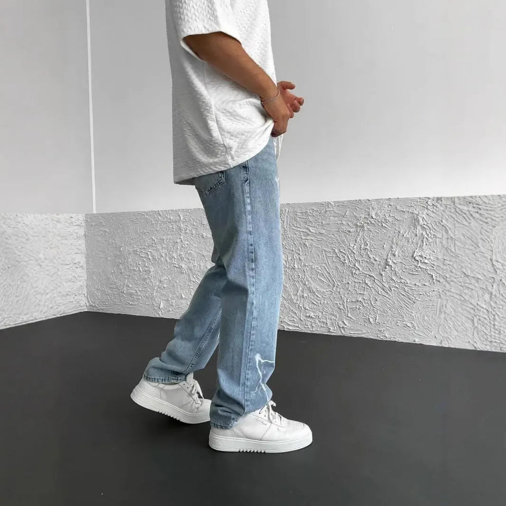 Blue men's straight-leg denim jeans with mid-waist fit and zipper fly displayed flat