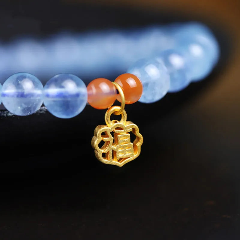 Women's crystal bracelet with ice translucent aquamarine 8mm round beads and sequin detailing on a white background.