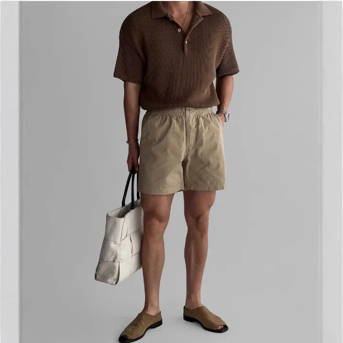 Cotton loose fit sports shorts in black, shown on a model for summer activewear.