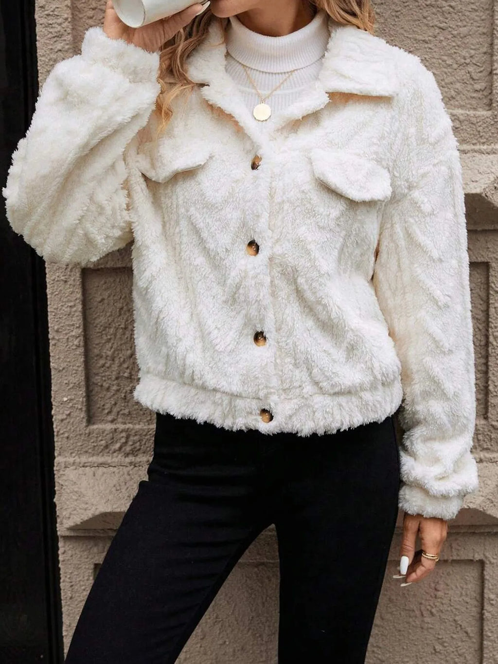 Ivory white women's double-sided plush button cardigan on a hanger.