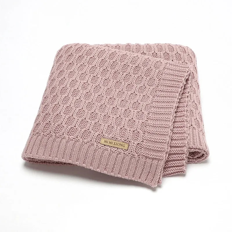 Solid colour acrylic infant blanket with textured lines measuring 70×90cm in pink, beige, grey, or green
