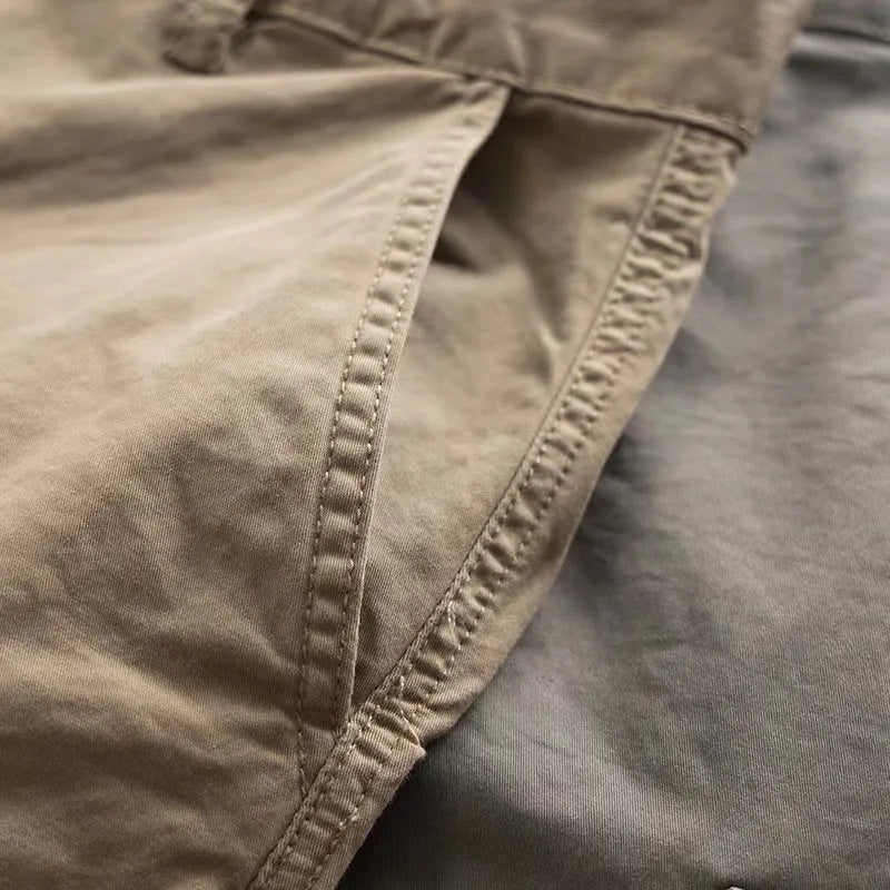 Men's multi-pocket cotton labour protection trousers in khaki, showing cropped leg length and solid colour design.