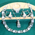 Four-piece bridal jewellery set showing alloy pendant necklace, bracelet, earrings, and ring on a white background.
