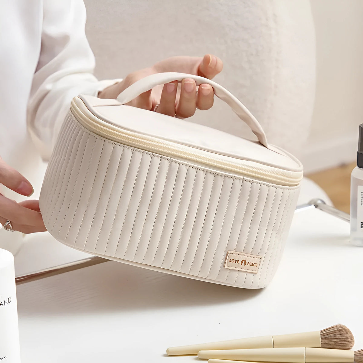 Open-top cake-shaped makeup bag in PU leather shown in a light colour, demonstrating its structured shape and easy-access design.