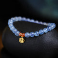 Women's crystal bracelet with ice translucent aquamarine 8mm round beads and sequin detailing on a white background.