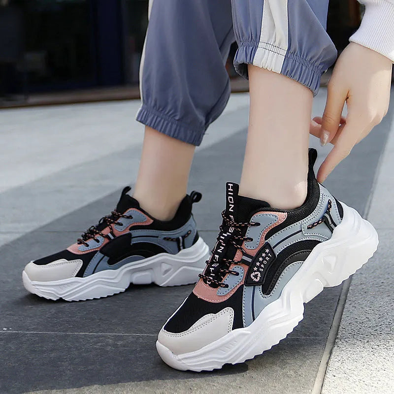 White women's casual sports shoes with mesh upper, thick PU sole, round toe, and buckle detail.