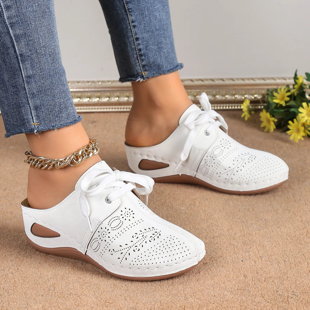 Women's black lace-up baotou slippers with a suede upper and rubber sole on a neutral background.