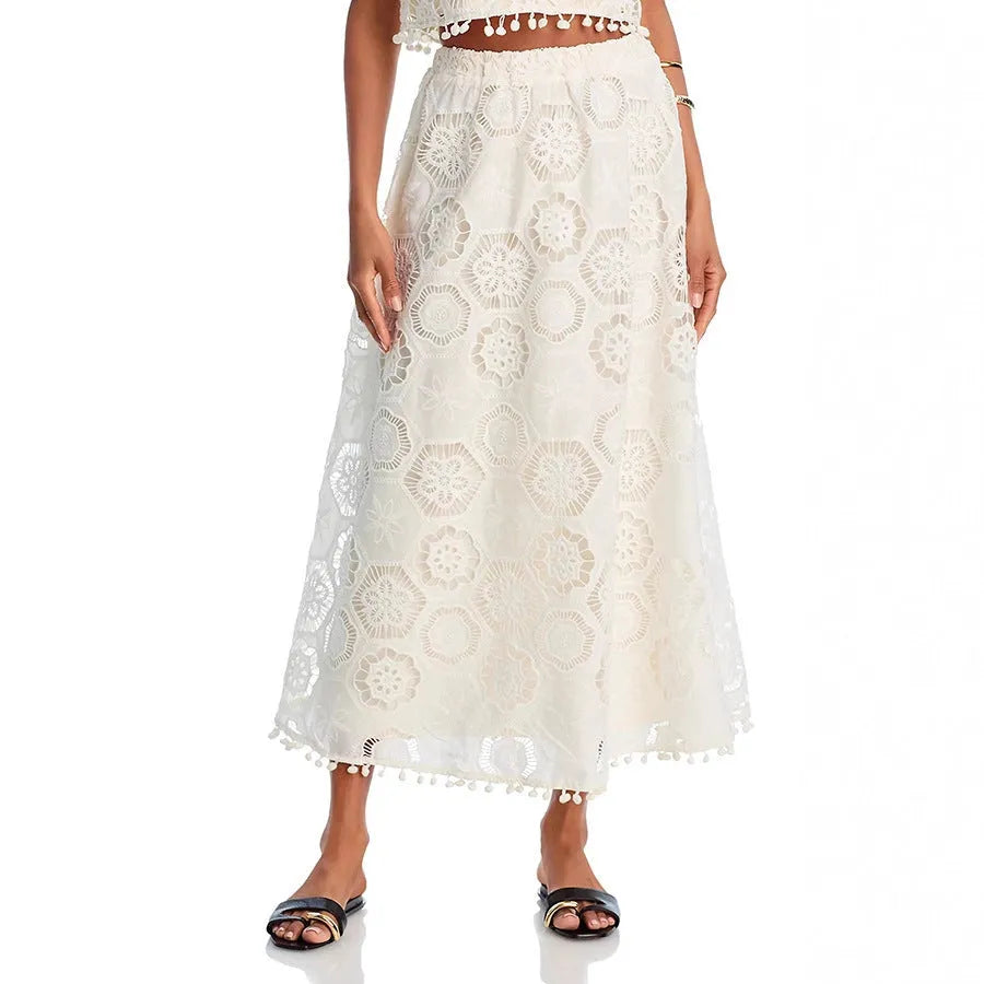 White women's sleeveless top and long skirt suit set with retro embroidery on a hanger