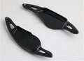 Steering wheel paddle shifter for car interior in various finishes including carbon fibre.