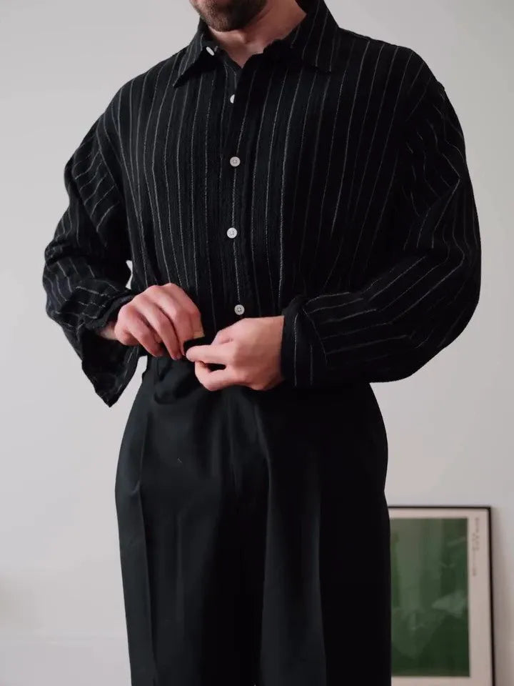 Black pinstripe button-down shirt on hanger showing striped pattern and button front