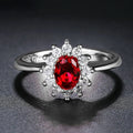 Women's blue moissanite flower ring in electroplated copper with inlaid zirconium, shown in green, blue, or red.