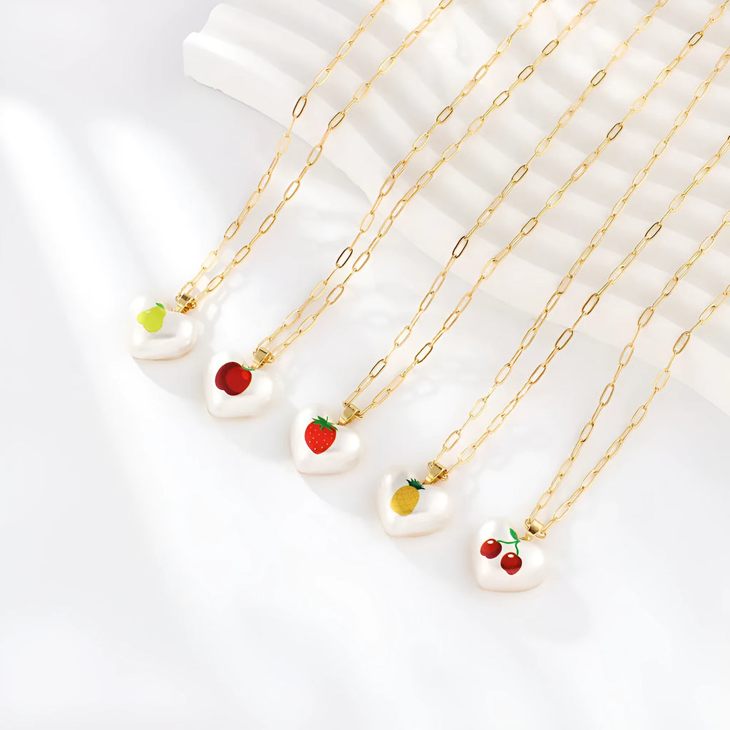 Geometric fruit pendant necklace on an adjustable chain, showing apple, cherry, pear, pineapple, and strawberry charm options.